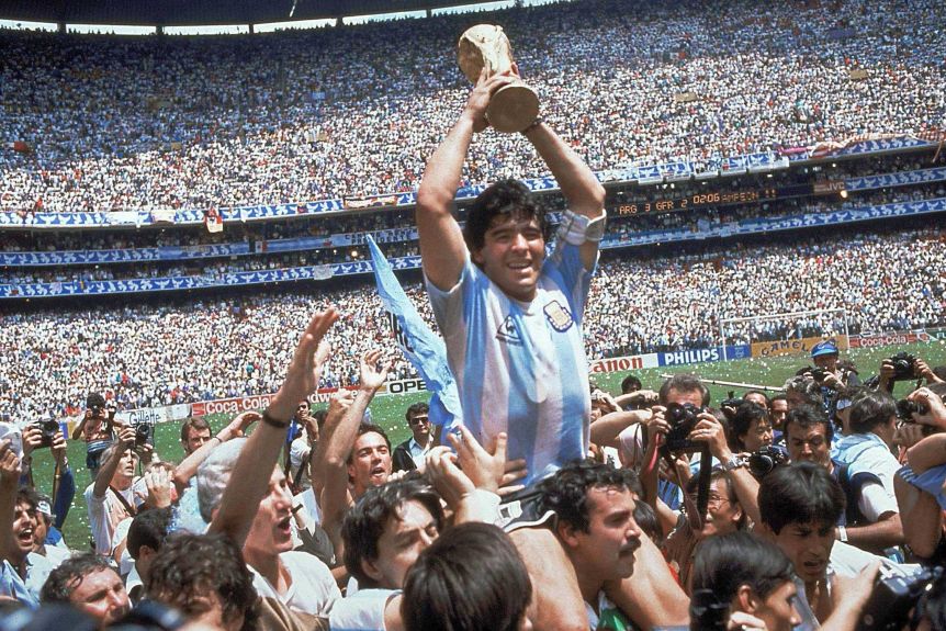 Argentinian football legend Diego Armando Maradona lifting the FIFA World Cup trophy in Mexico circa 1986