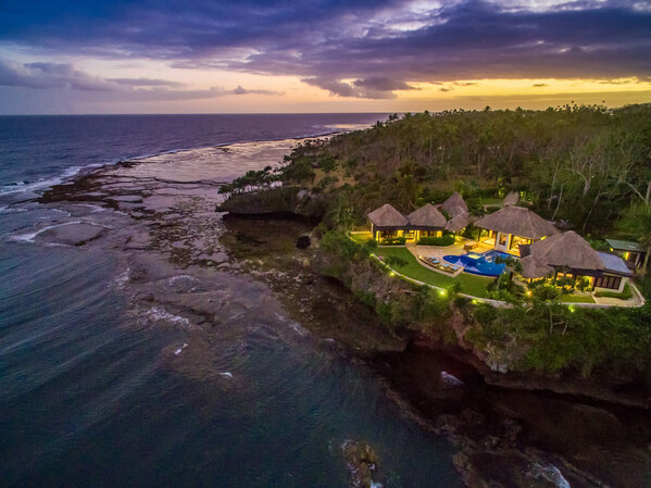 The Signature Villa glows as the sun sets over the South Pacific Ocean. FijiLuxuryAuction.com. The Signature Villa glows as the sun sets over the South Pacific Ocean. FijiLuxuryAuction.com.